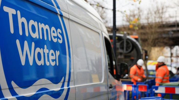 A Thames Water van on a road, near staff carrying out repairs and maintenance in London, England in December 2024